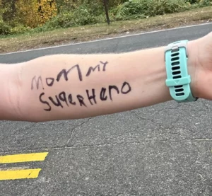 Image of "Mommy Superhero" written on an arm.