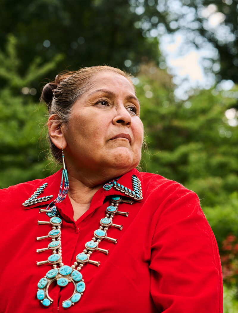 Headshot of Native American in traditional clothing and jewelry.