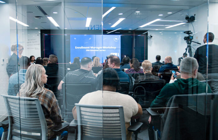 Audience waits for a presentation from VBA Education Service