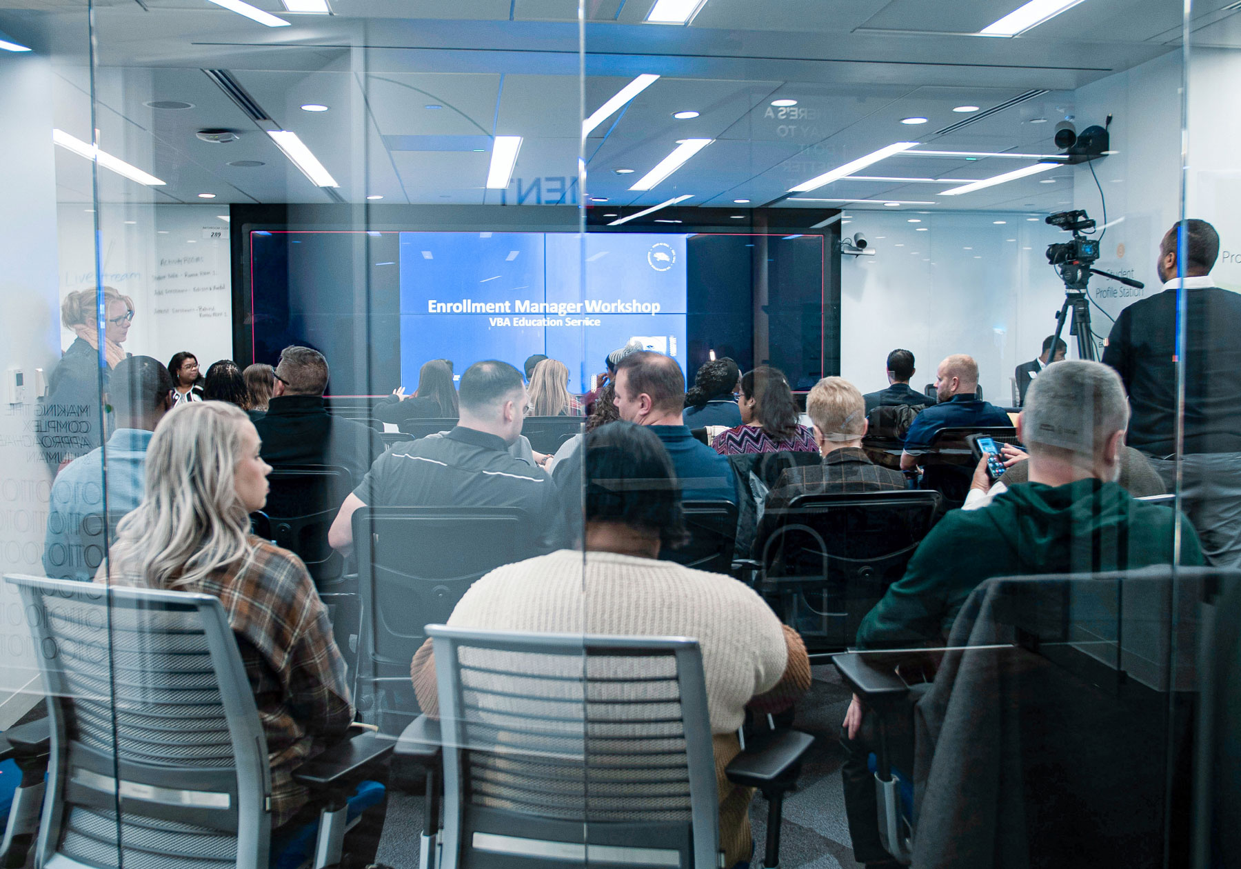 Audience waits for a presentation from VBA Education Service