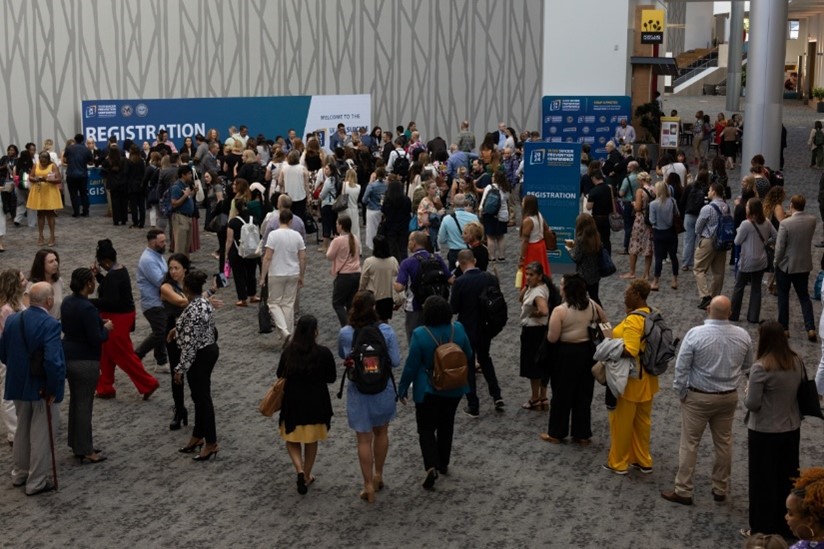 Attendees checking in at registration at the 2024 VA/DoD Suicide Prevention Conference.