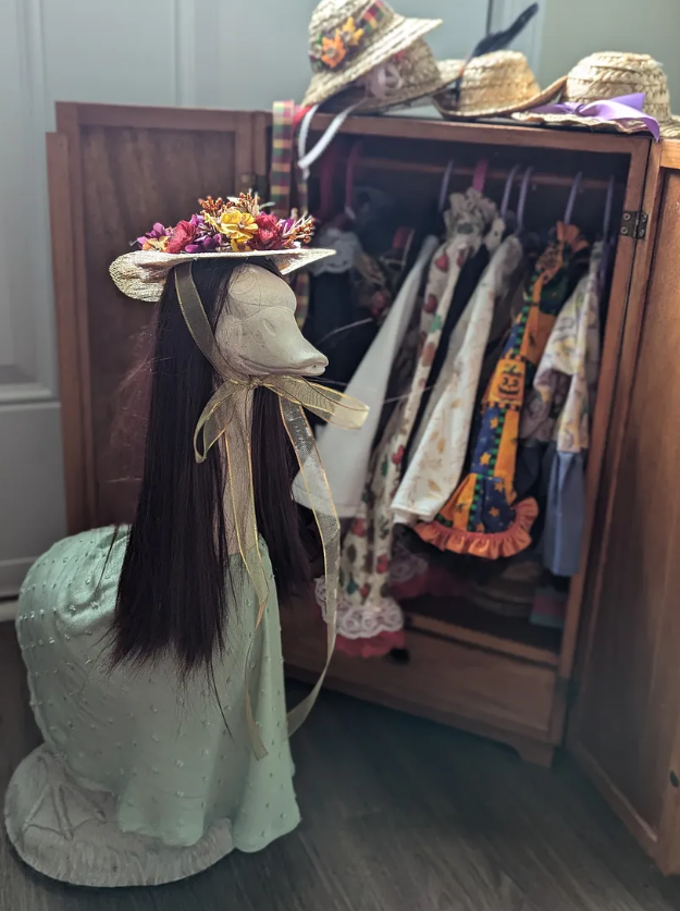 Ruth, the Midwest porch goose, with her wardrobe of costumes.