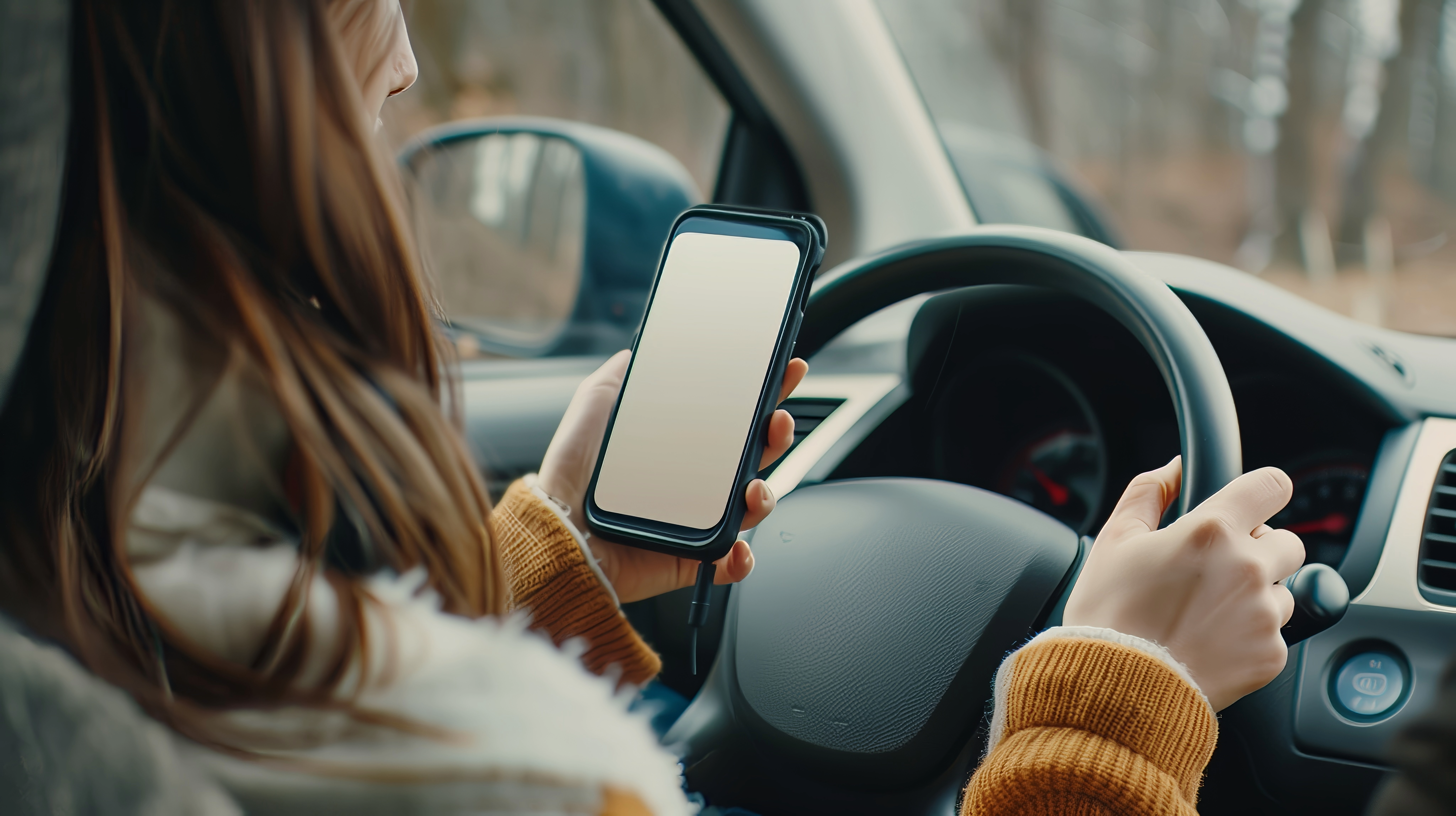 A person texting while driving.