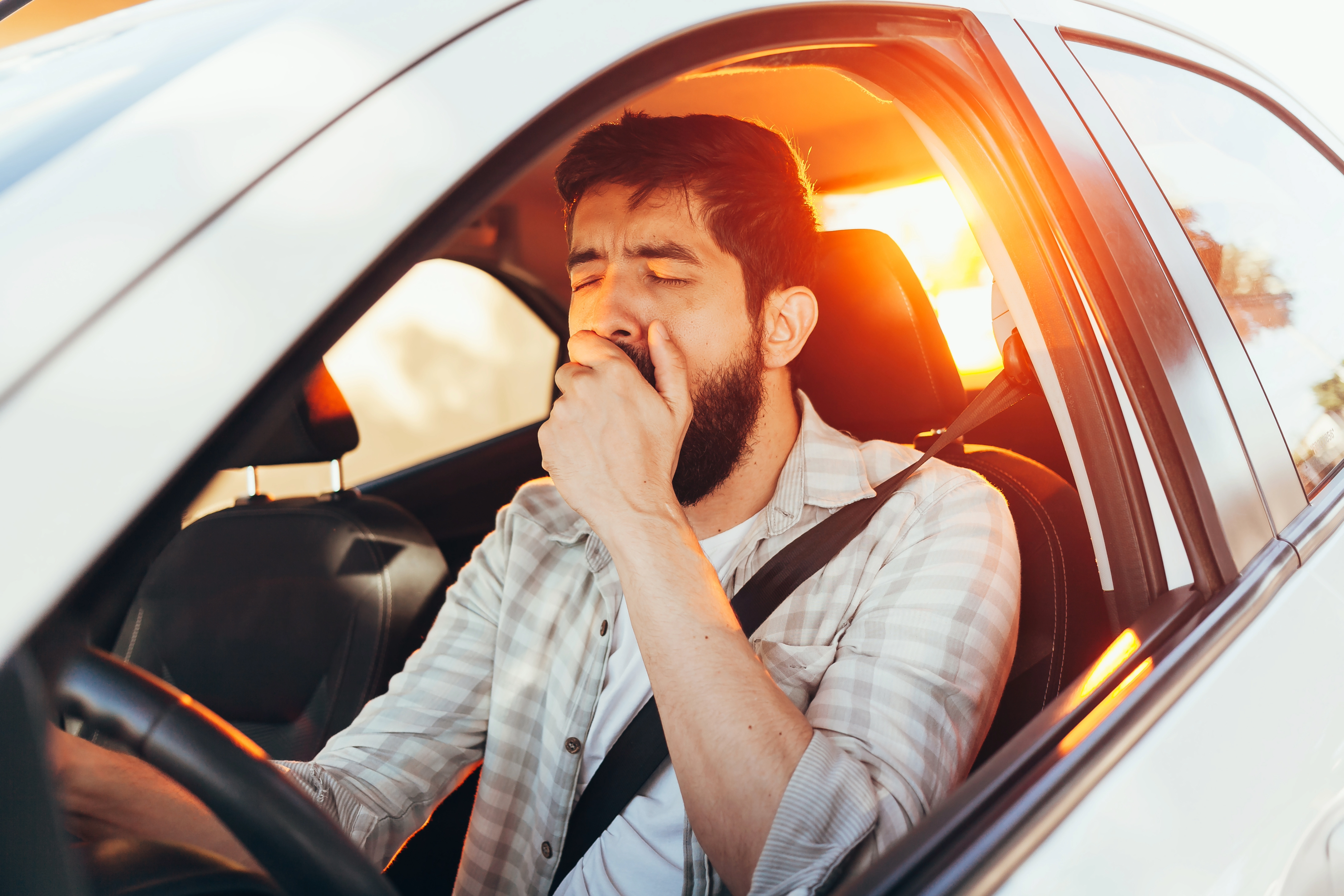 Image of a person driving while drowsy.