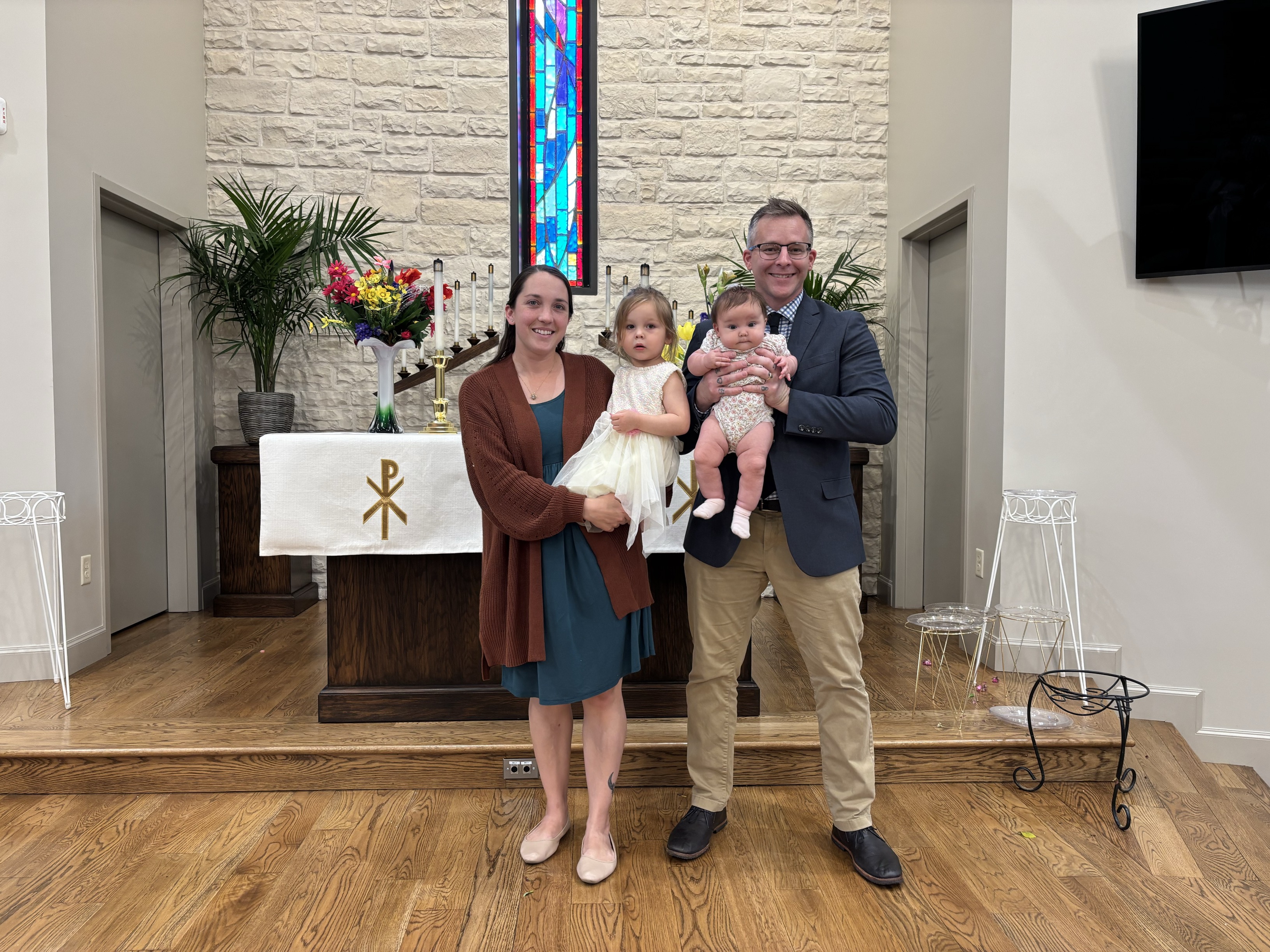 Family smiling inside of a church.